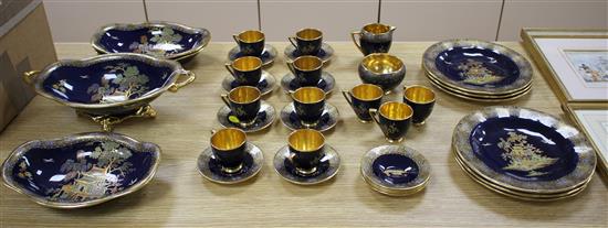 A Carltonware thirty five piece coffee and dessert service, with chinoiserie decoration on a dark blue ground